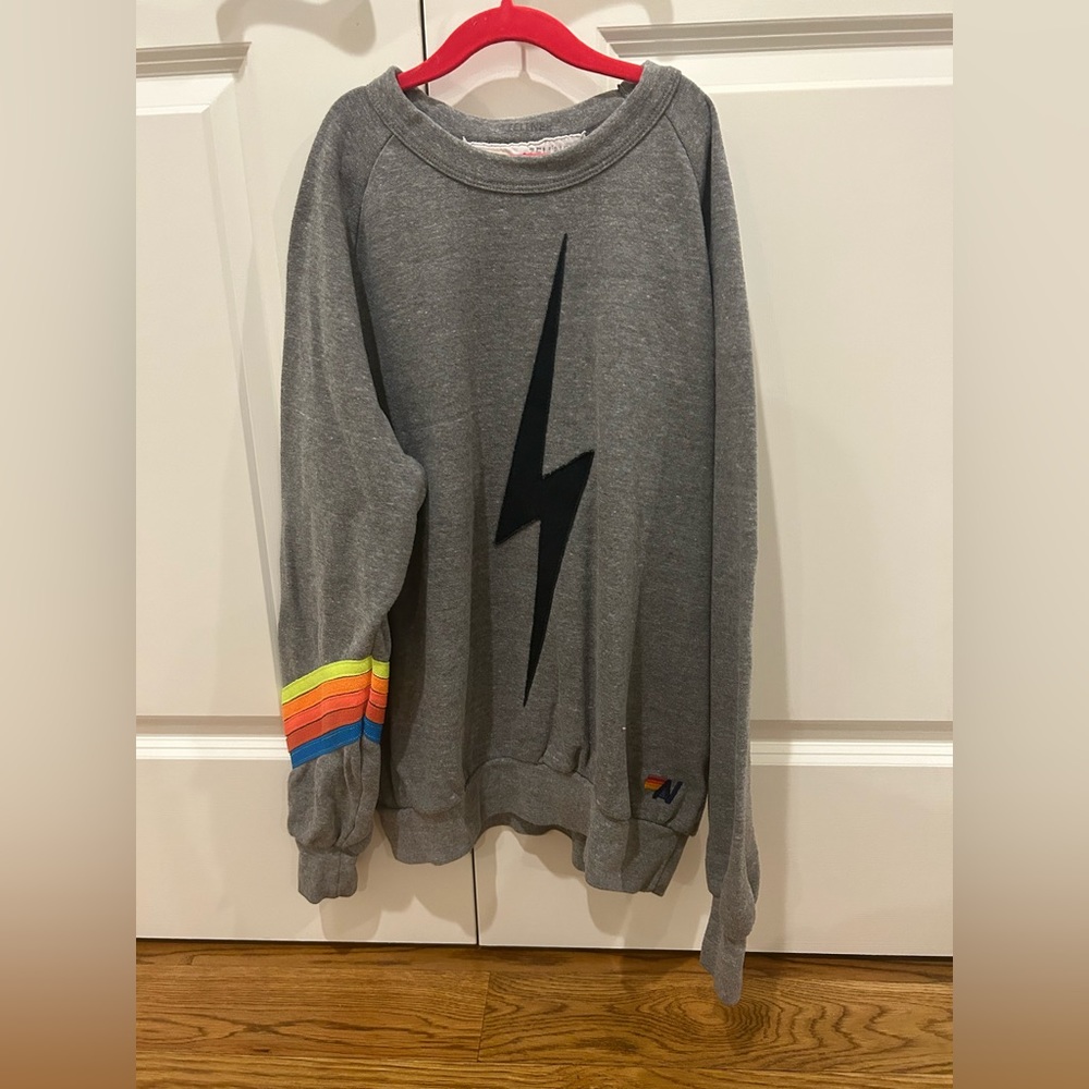 gray Aviator Nation lightning bolt crewneck with neon stripes on the sleeve